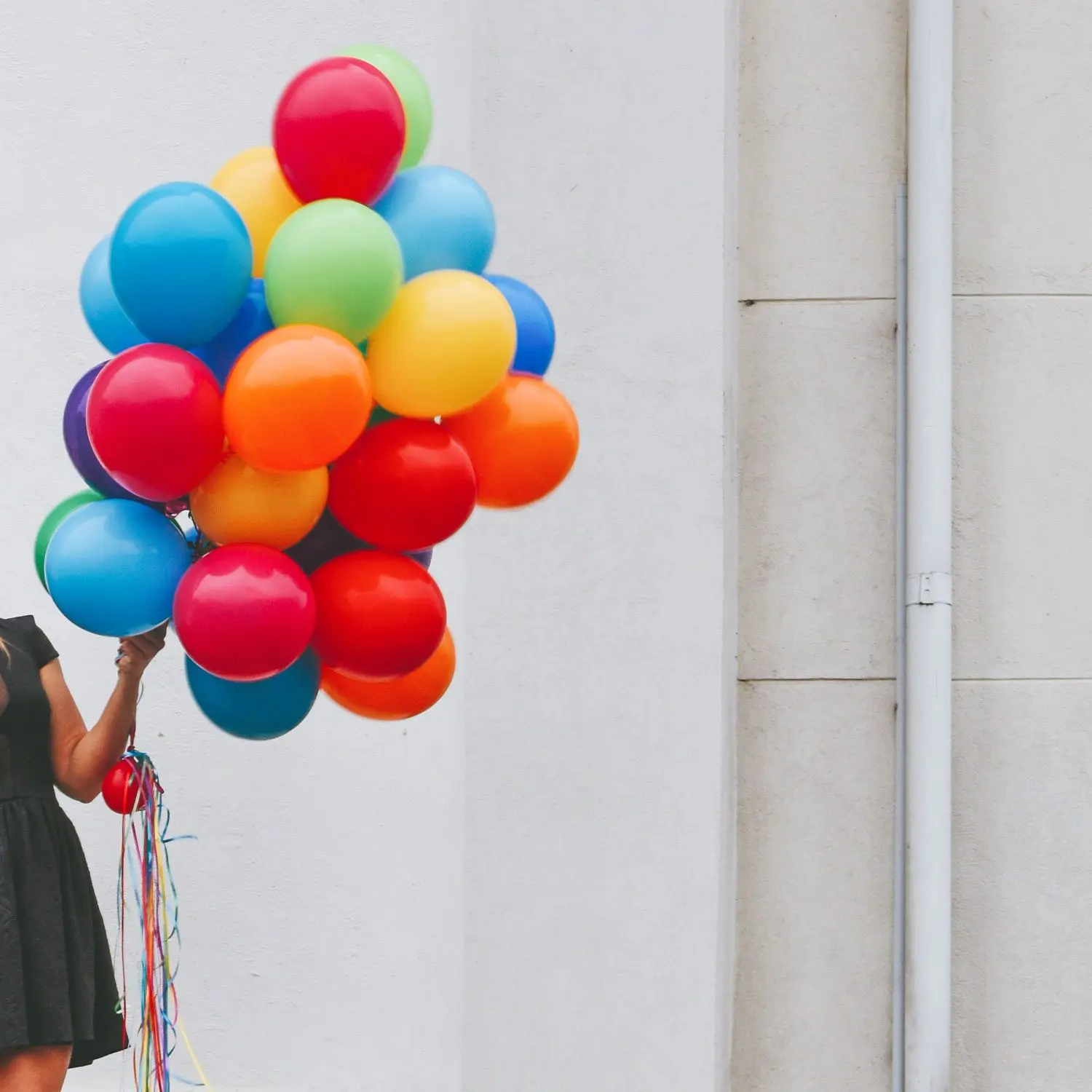 WomanHoldingBalloons Large rainbow balloon bouquet